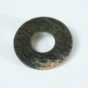 Lot 010 A LARGE ARCHAISTIC CELADON JADE 'CLOUD AND THUNDER' BI-DISC
HAN DYNASTY OR LATER