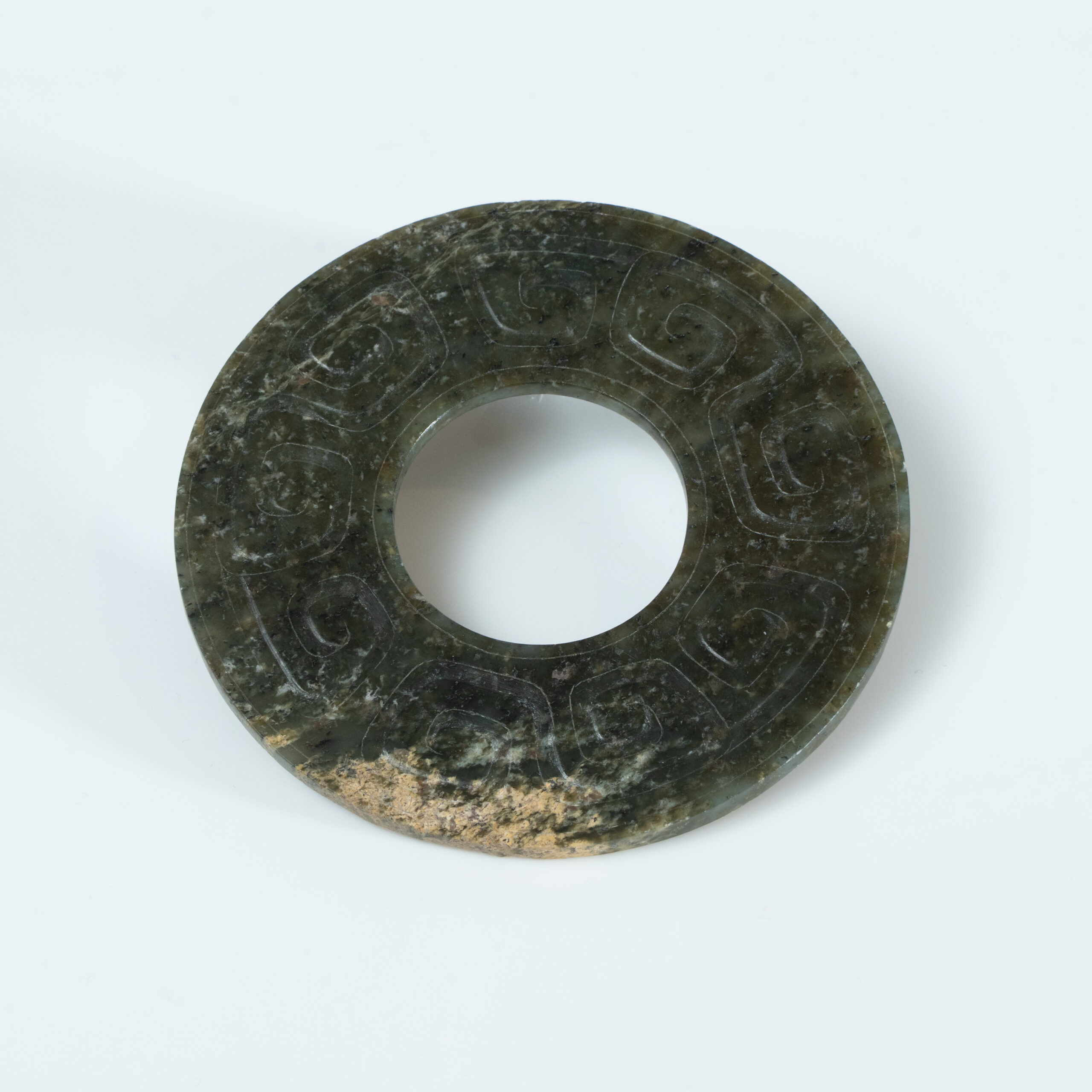 Lot 010 A LARGE ARCHAISTIC CELADON JADE 'CLOUD AND THUNDER' BI-DISC
HAN DYNASTY OR LATER - Image 2
