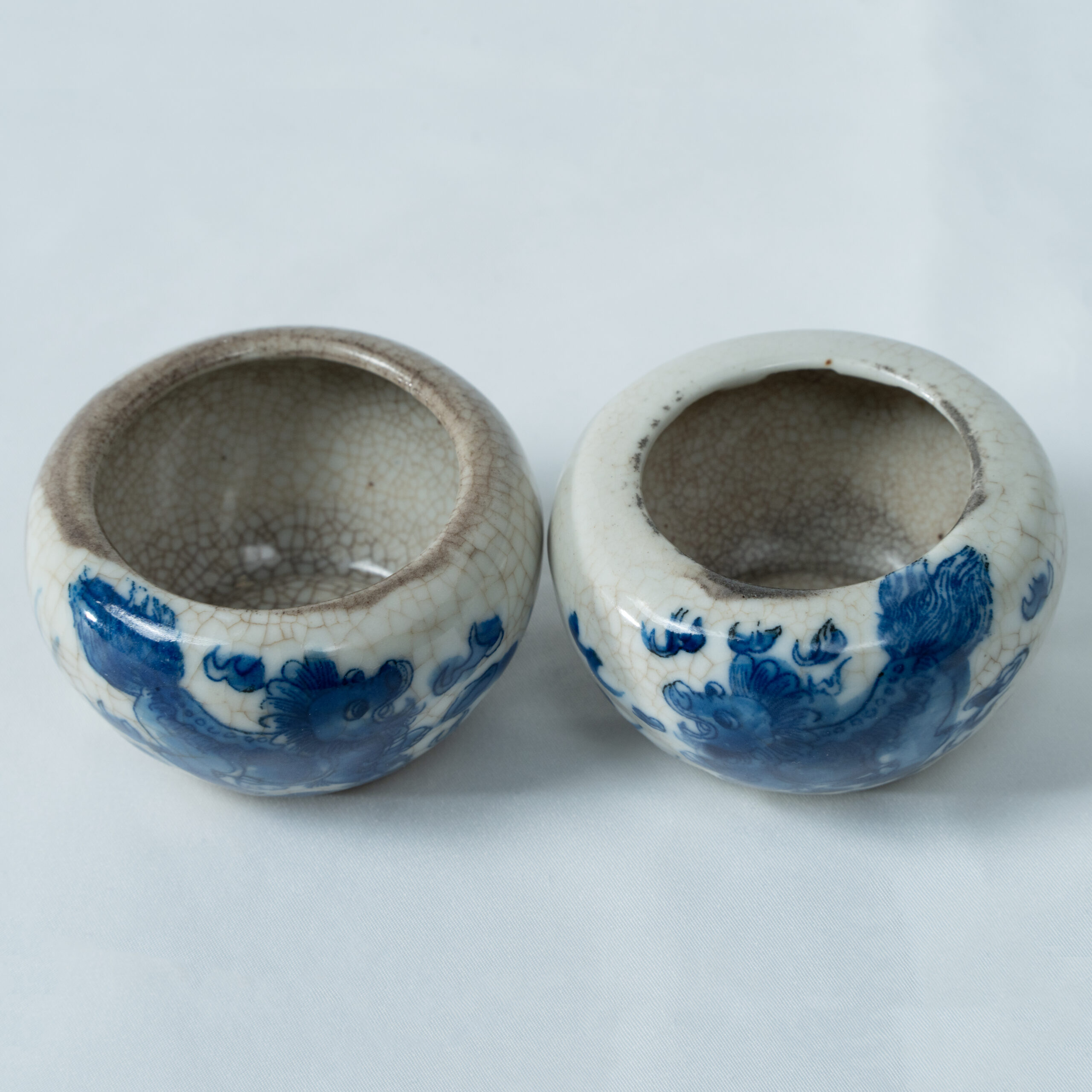 Lot 029 A PAIR OF CHINESE BLUE AND WHITE 'BUDDHIST LIONS' CRACKLE-GLAZED WATER POTS
QING DYNASTY