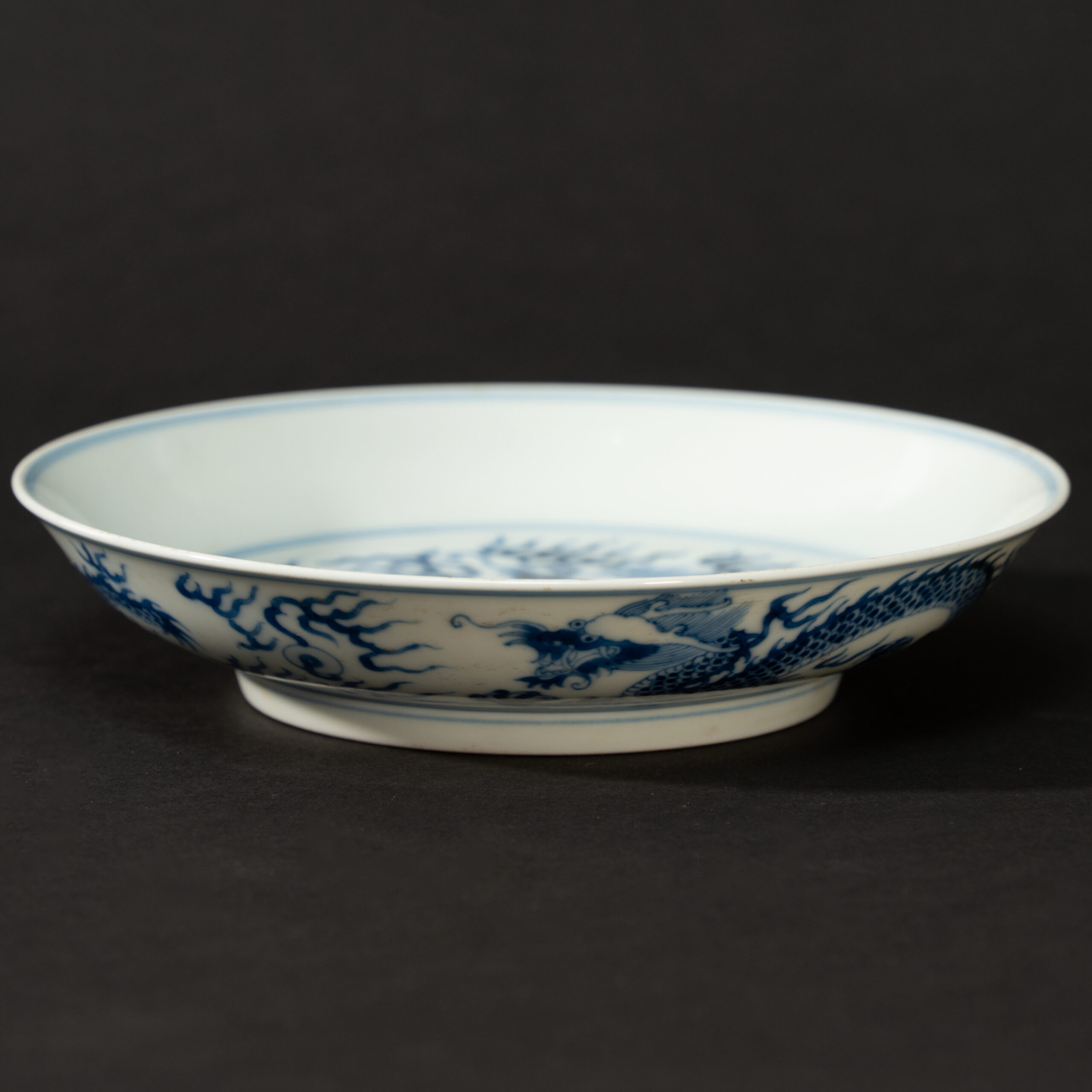 Lot 047 A BLUE AND WHITE 'DRAGON' DISH
20TH CENTURY, GUANGXU MARK