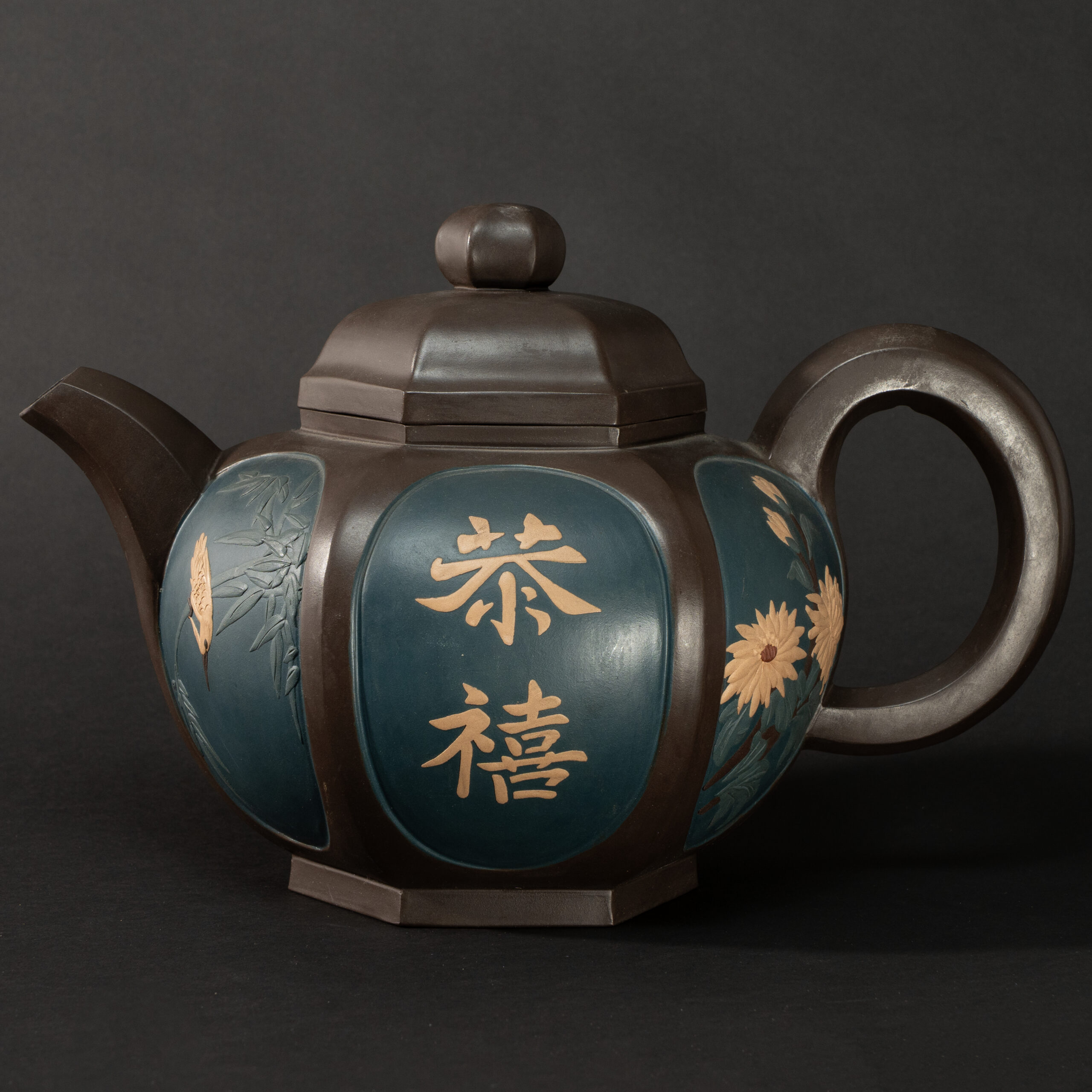 Lot 053 A LARGE HEXAGONAL PURPLE CLAY 'FLORAL AND CALLIGRAPHY' TEAPOT
MODERN